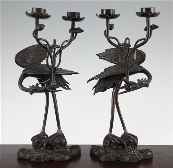 A pair of Japanese crane candelabra, late 19th century, 31.5cm., repairs